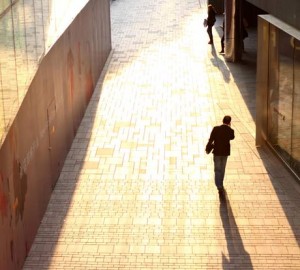 Man in business suit walking in the sunshine