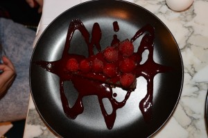 Dark chocolate tart atop with berries